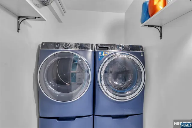 a large kitchen with a lot of cabinets and stainless steel appliances