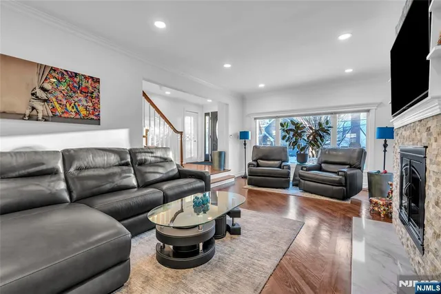 a living room with furniture a fireplace and a flat screen tv