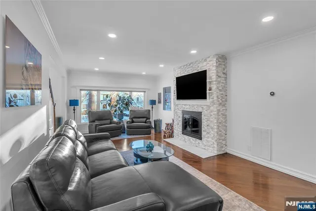 a living room with fireplace furniture and a flat screen tv