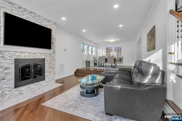 a living room with lots of furniture and kitchen view