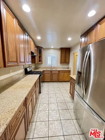 a view of a livingroom with an empty space and a window