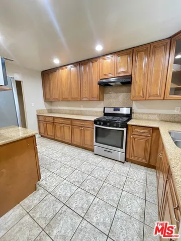 a view of a livingroom with wooden floor and a hallway