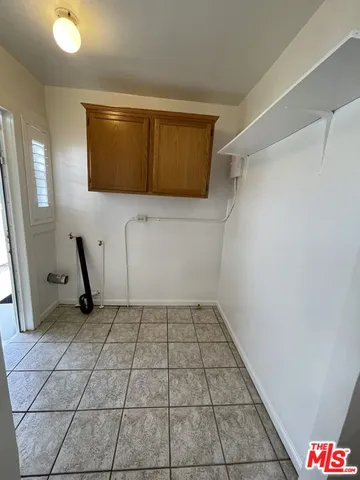 a kitchen with granite countertop a sink stove and cabinets