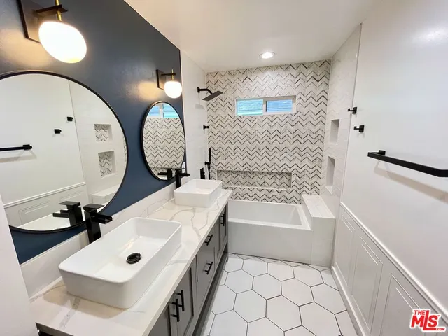 a bathroom with a sink a toilet and mirror