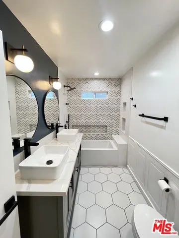 a bathroom with a bathtub and a shower