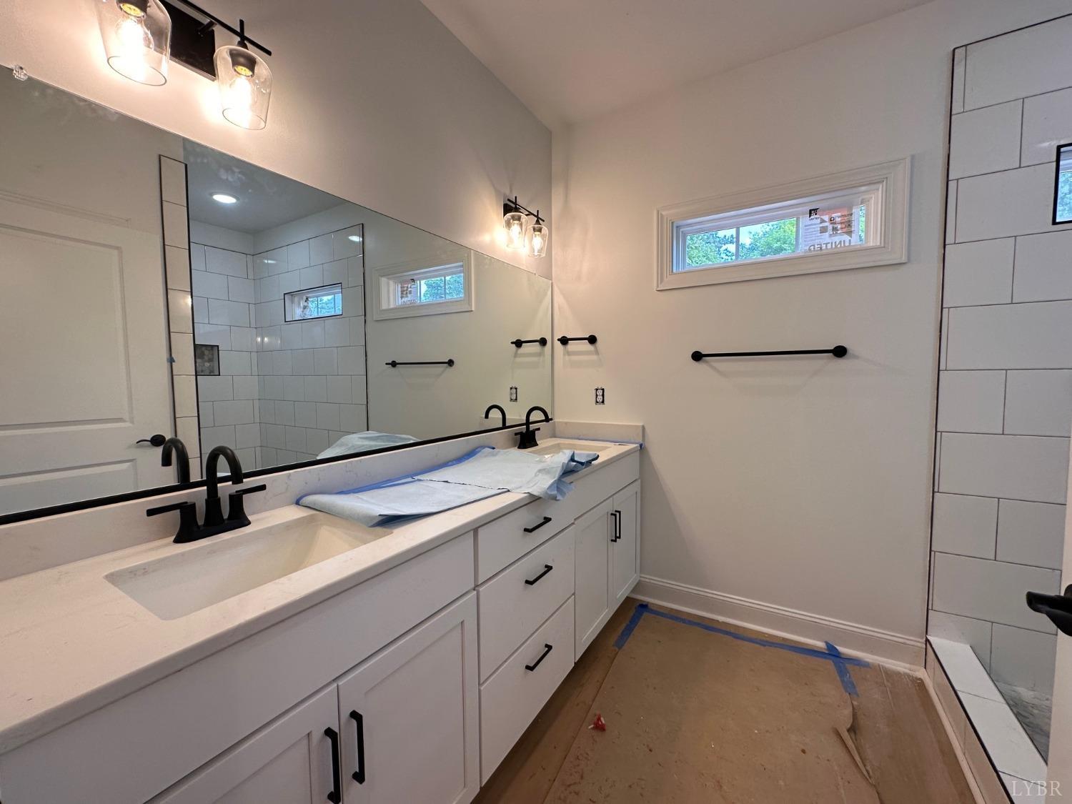 2811 Everett Road Forest, VA 24551 - Photo 17 of 49 a bathroom with a sink and a mirror