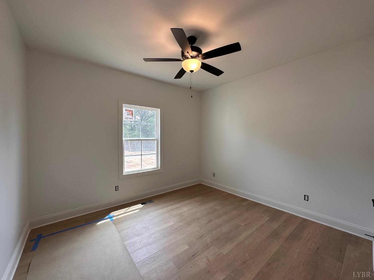 2811 Everett Road Forest, VA 24551 - Photo 23 of 49 an empty room with a window and a fan