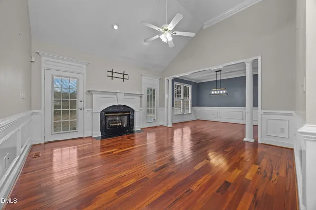 wooden floor in an empty room with a fireplace