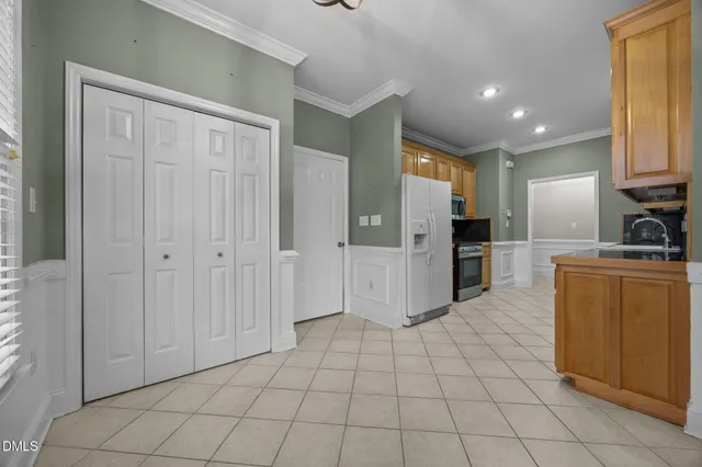a kitchen with stainless steel appliances granite countertop a refrigerator and a sink