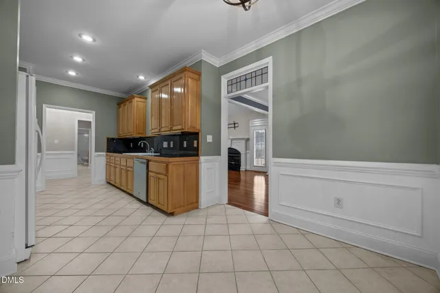 a kitchen with granite countertop a stove and a refrigerator