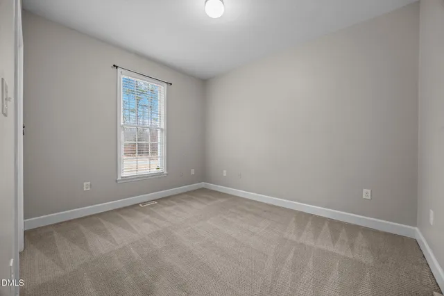 an empty room with fan and a ceiling fan
