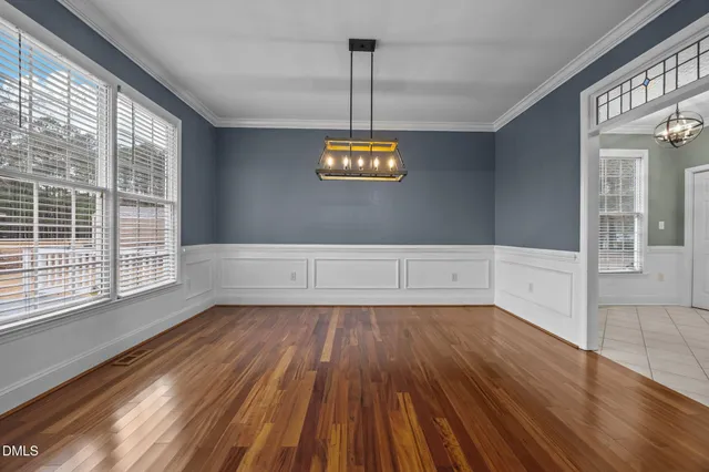 a view of a room with wooden floor and window