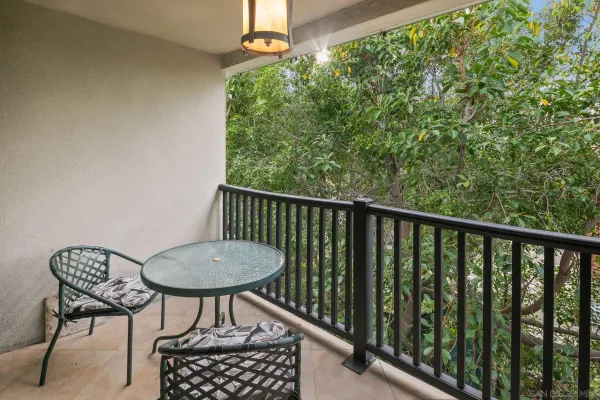 a balcony with table and chairs