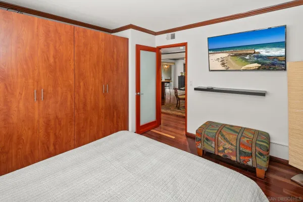 a large bed sitting in a bedroom next to a window