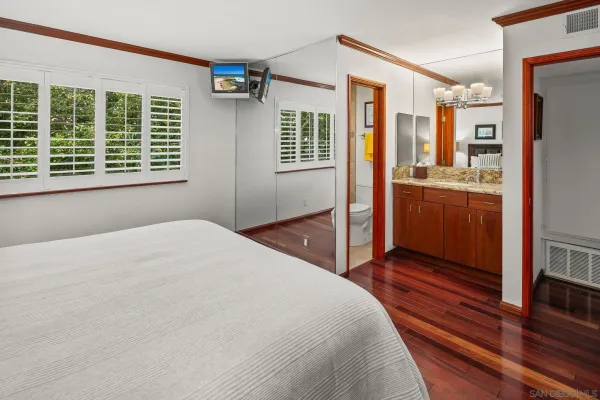 a bedroom with a large bed and a large dresser