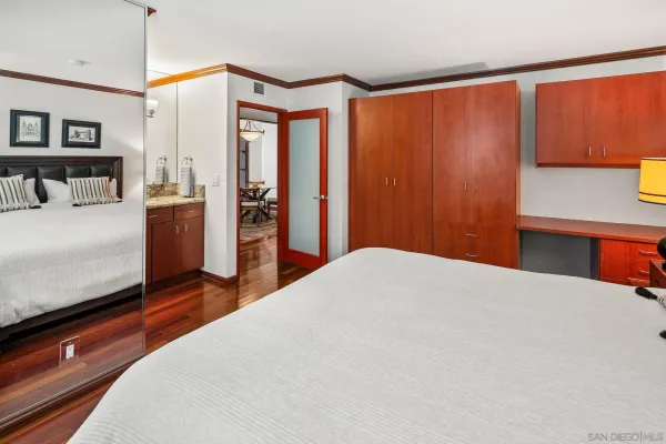 a bedroom with a bed and a night stand