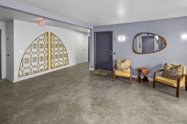 a view of a hallway with wooden floor and closet