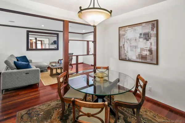 a dining room with furniture and wooden floor
