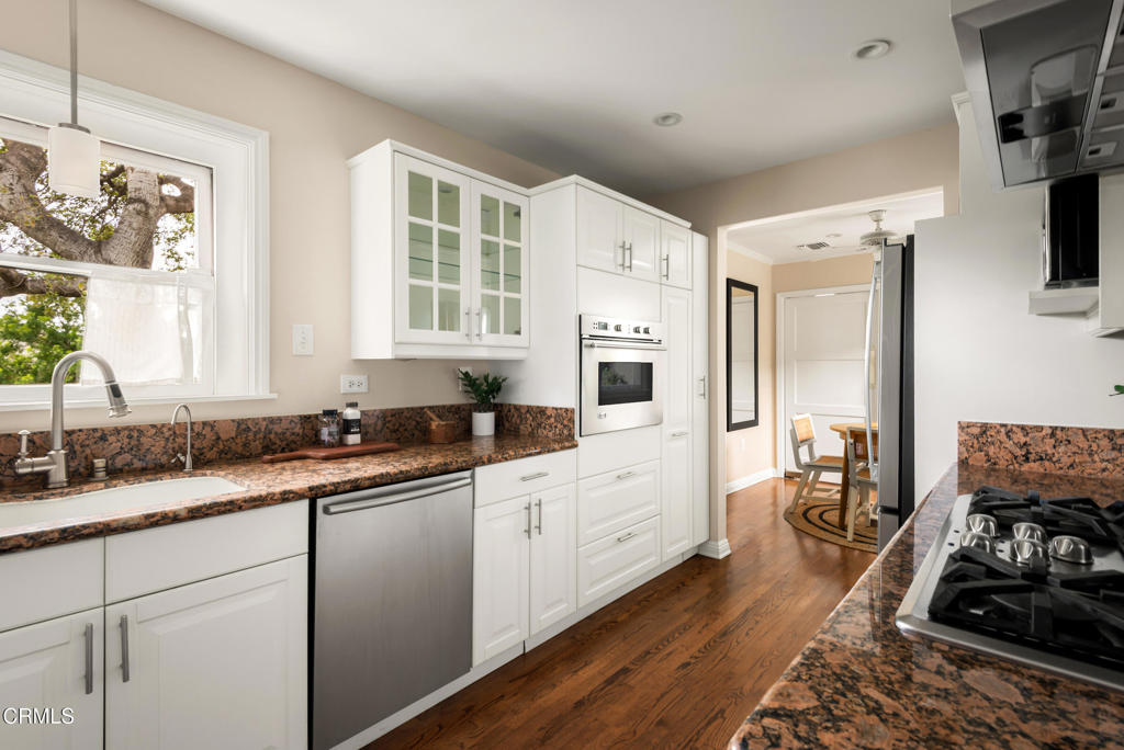 1873 North Harding Avenue Altadena, CA 91001 - Photo 17 of 55 a kitchen with granite countertop a sink stove and cabinets