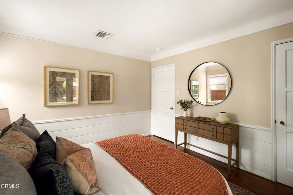 1873 North Harding Avenue Altadena, CA 91001 - Photo 24 of 55 a bedroom with a bed a mirror and a potted plant