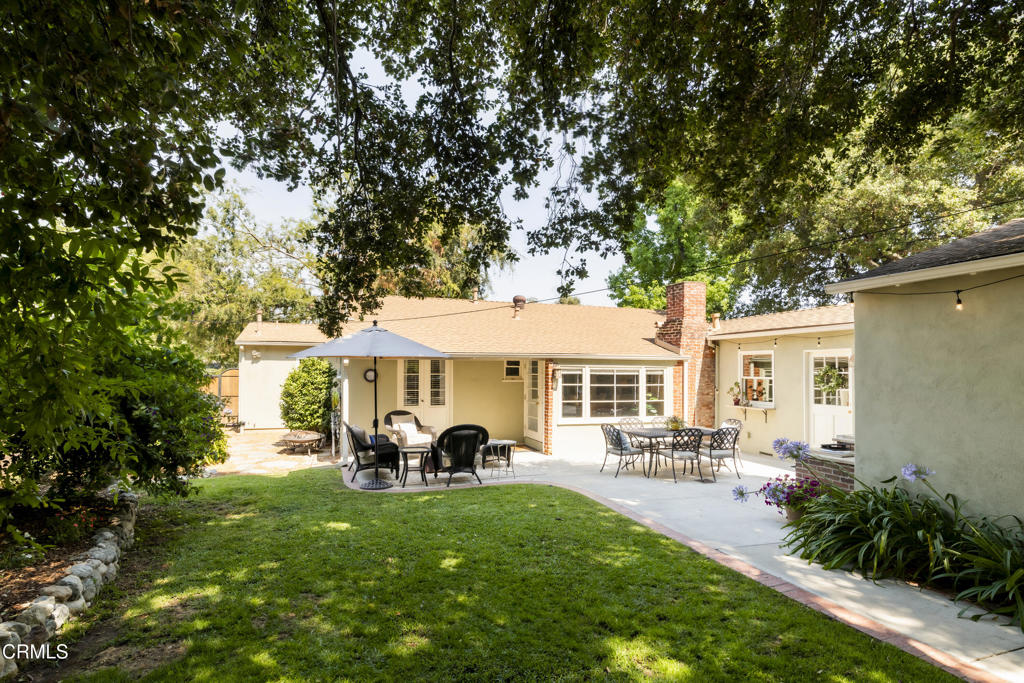 1873 North Harding Avenue Altadena, CA 91001 - Photo 43 of 55 a view of a patio with table and chairs potted plants and large tree