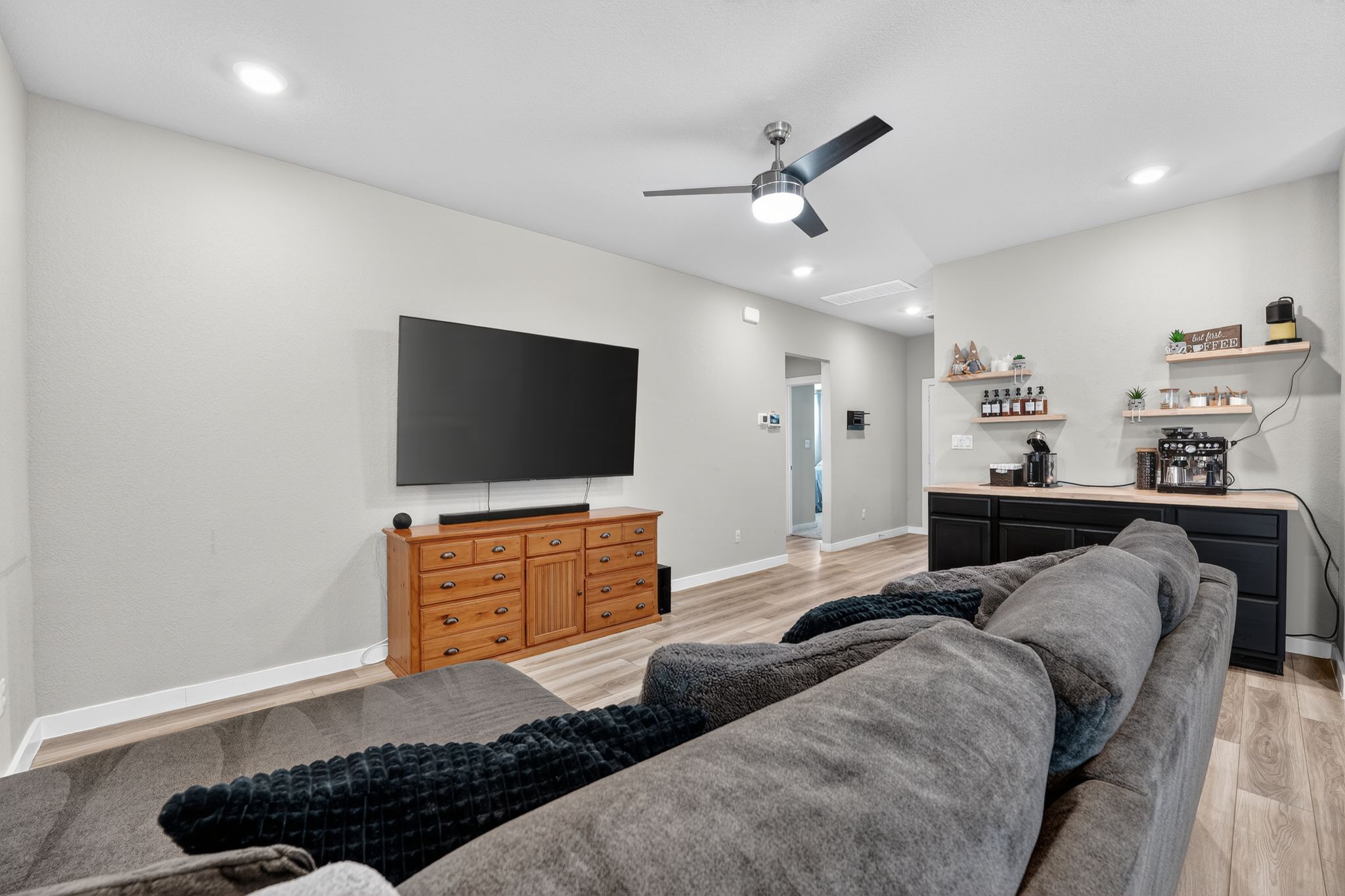117 Halford Road Georgetown, TX 78633 - Photo 6 of 31 Living room featuring light wood-style flooring, a ceiling fan, recessed lighting, and bar