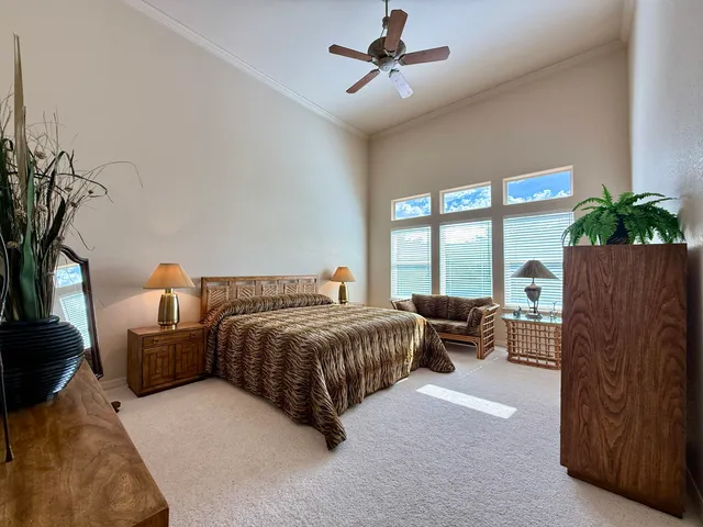 a bedroom with a bed and ceiling fan