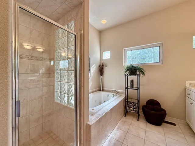 a spacious bathroom with a sink and a mirror