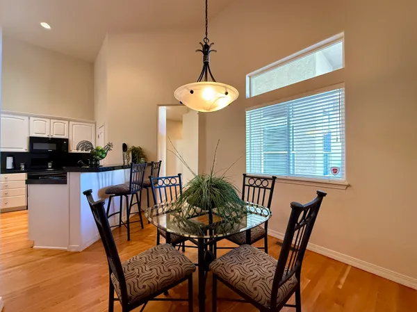 a kitchen with stainless steel appliances granite countertop a sink and a wooden floor