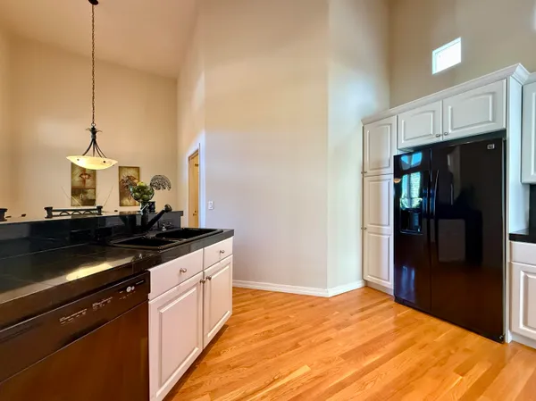 a kitchen with stainless steel appliances granite countertop a stove a refrigerator and a microwave