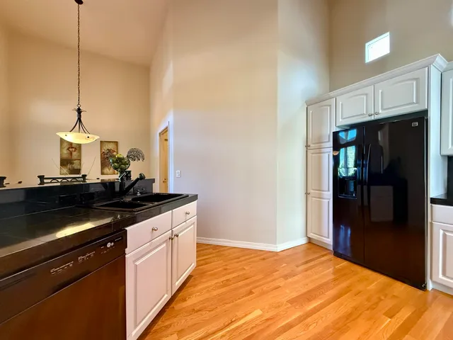 a kitchen with stainless steel appliances granite countertop a stove a refrigerator and a microwave