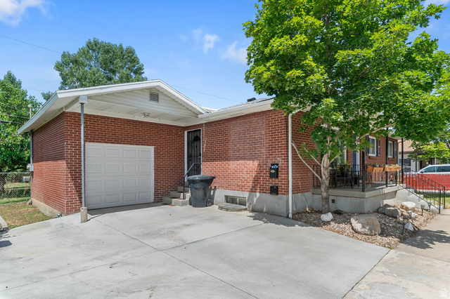 1489 North 400 West Bountiful, UT 84010 - Photo 40 of 47 Brick exterior home featuring a covered front entry, concrete driveway, and an attached garage with a white panel door