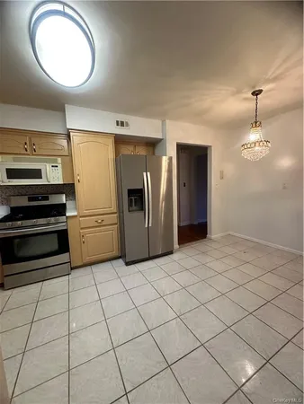 a kitchen with granite countertop a refrigerator and a sink