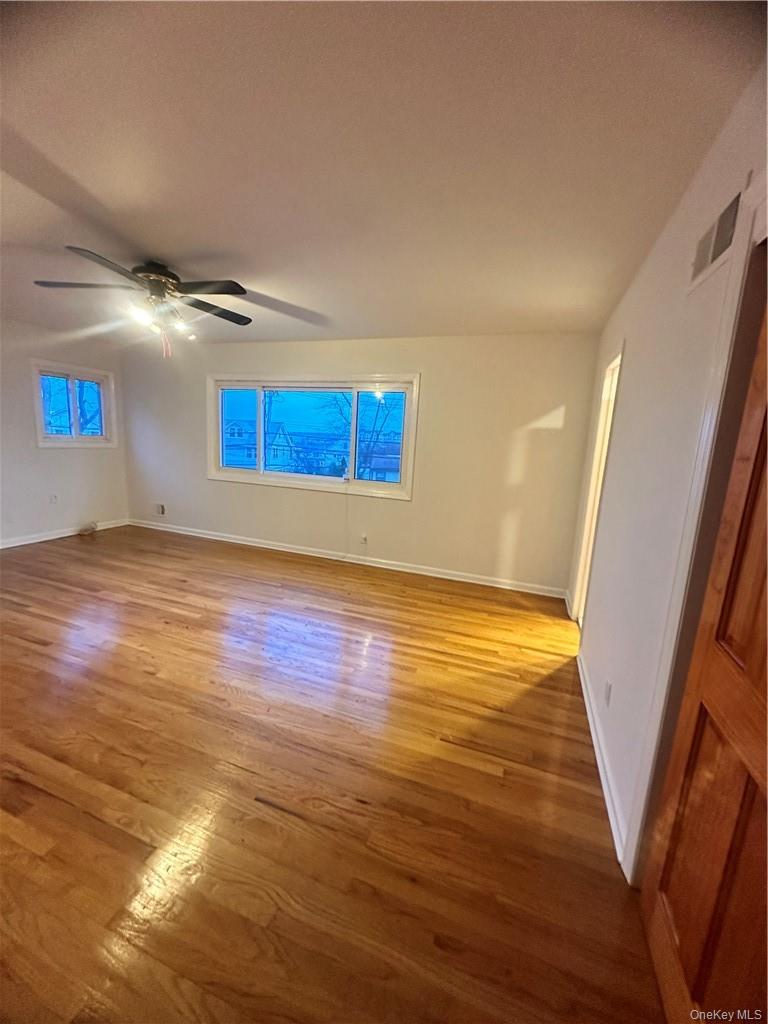 545 Pelham Road New Rochelle, NY 10805 - Photo 18 of 25 a view of an empty room with wooden floor and a window