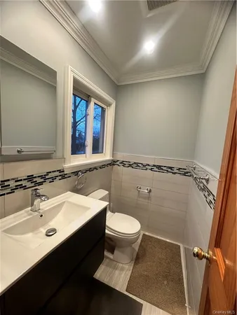 a bathroom with a sink mirror toilet and shower