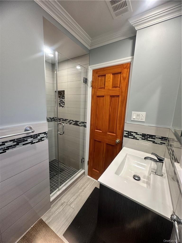 545 Pelham Road New Rochelle, NY 10805 - Photo 20 of 25 a bathroom with a sink mirror toilet and shower