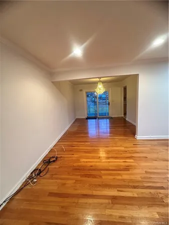 a view of a room with wooden floor