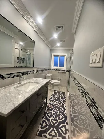 a bathroom with a granite countertop sink a mirror and a
