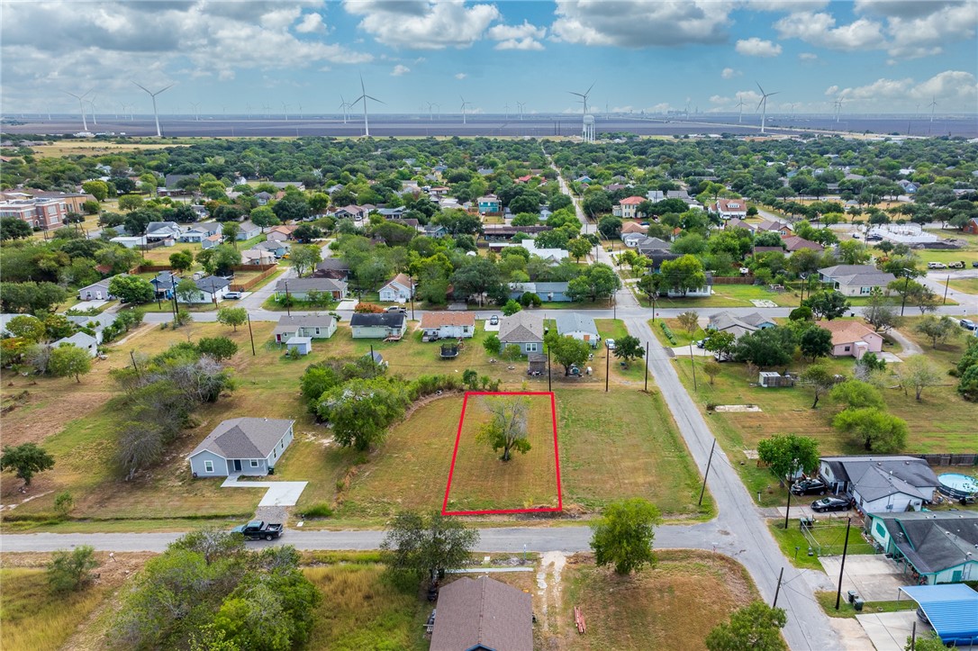 an aerial view of residential houses with outdoor space and lake view