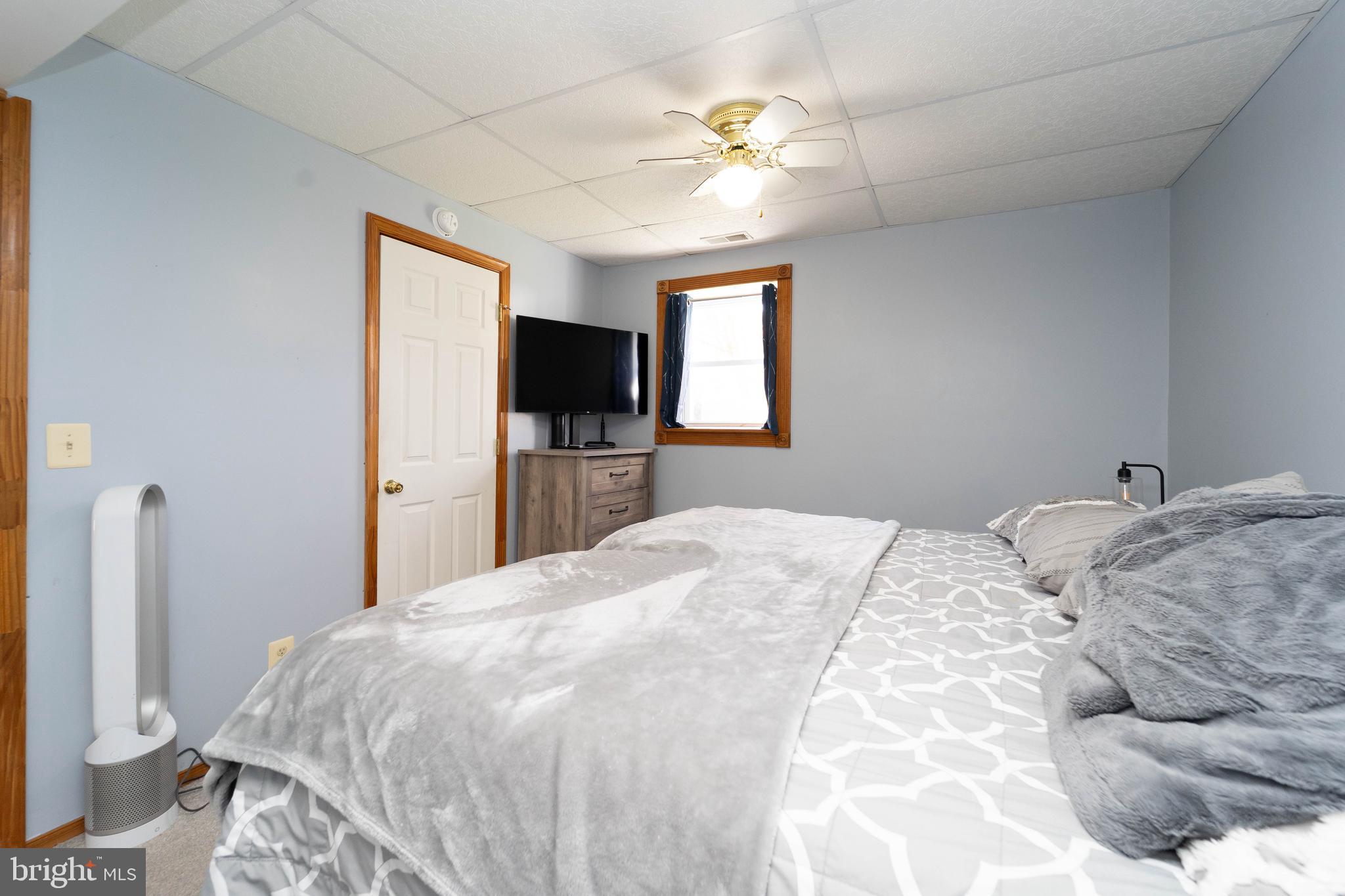 120 Tennessee Road Stevensville, MD 21666 - Photo 30 of 49 a bedroom with a bed and a flat screen tv