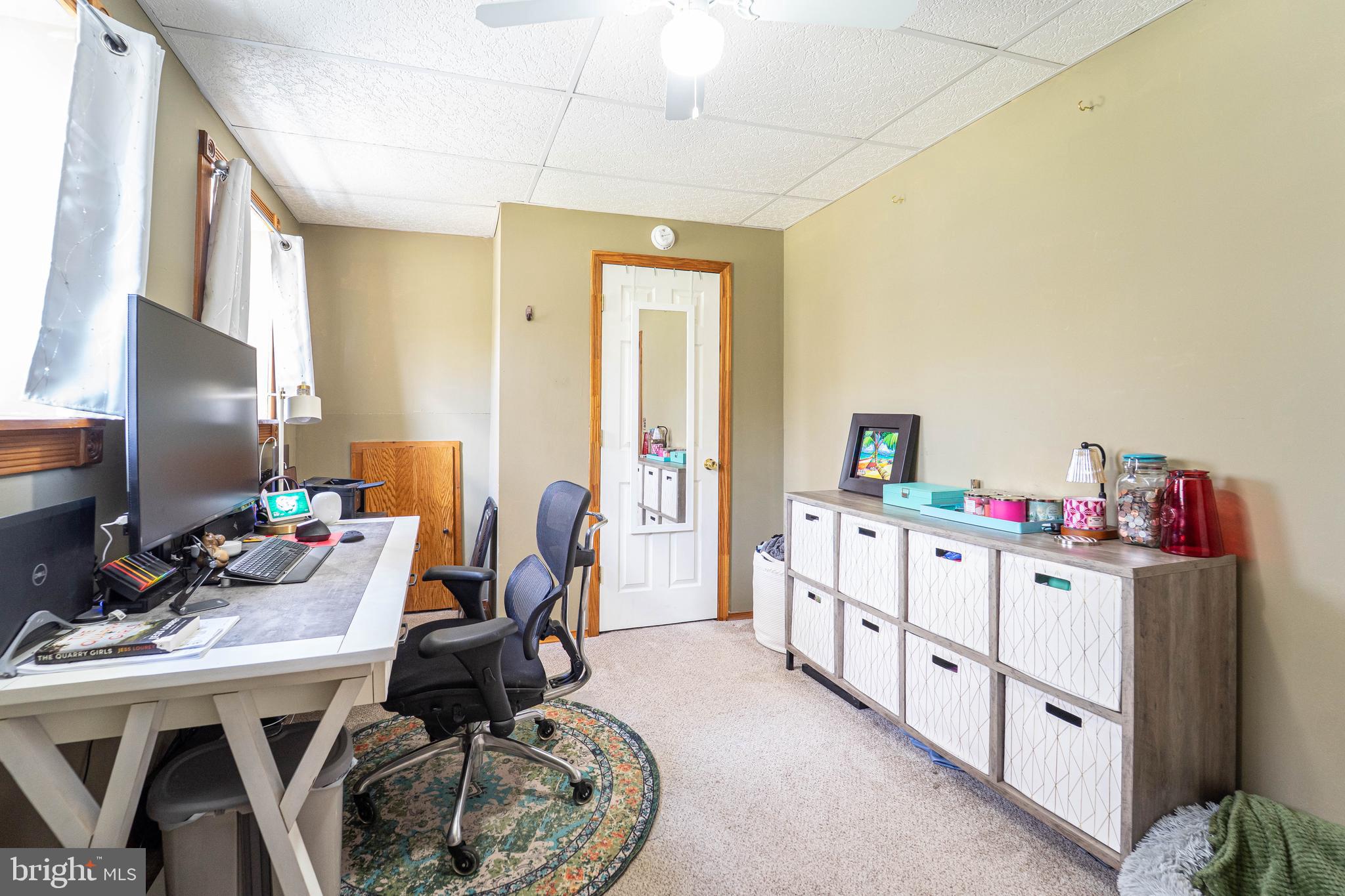 120 Tennessee Road Stevensville, MD 21666 - Photo 33 of 49 a room with furniture a desk and chair with the front door