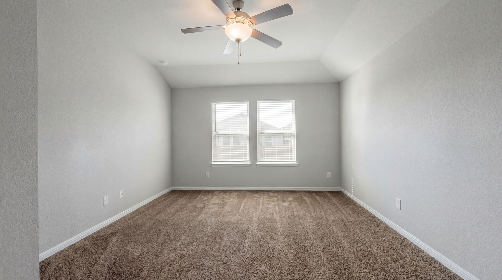 1003 Round Bale Road Hutto, TX 78634 - Photo 27 of 29 Spare room with dark colored carpet, ceiling fan, lofted ceiling, and a textured wall