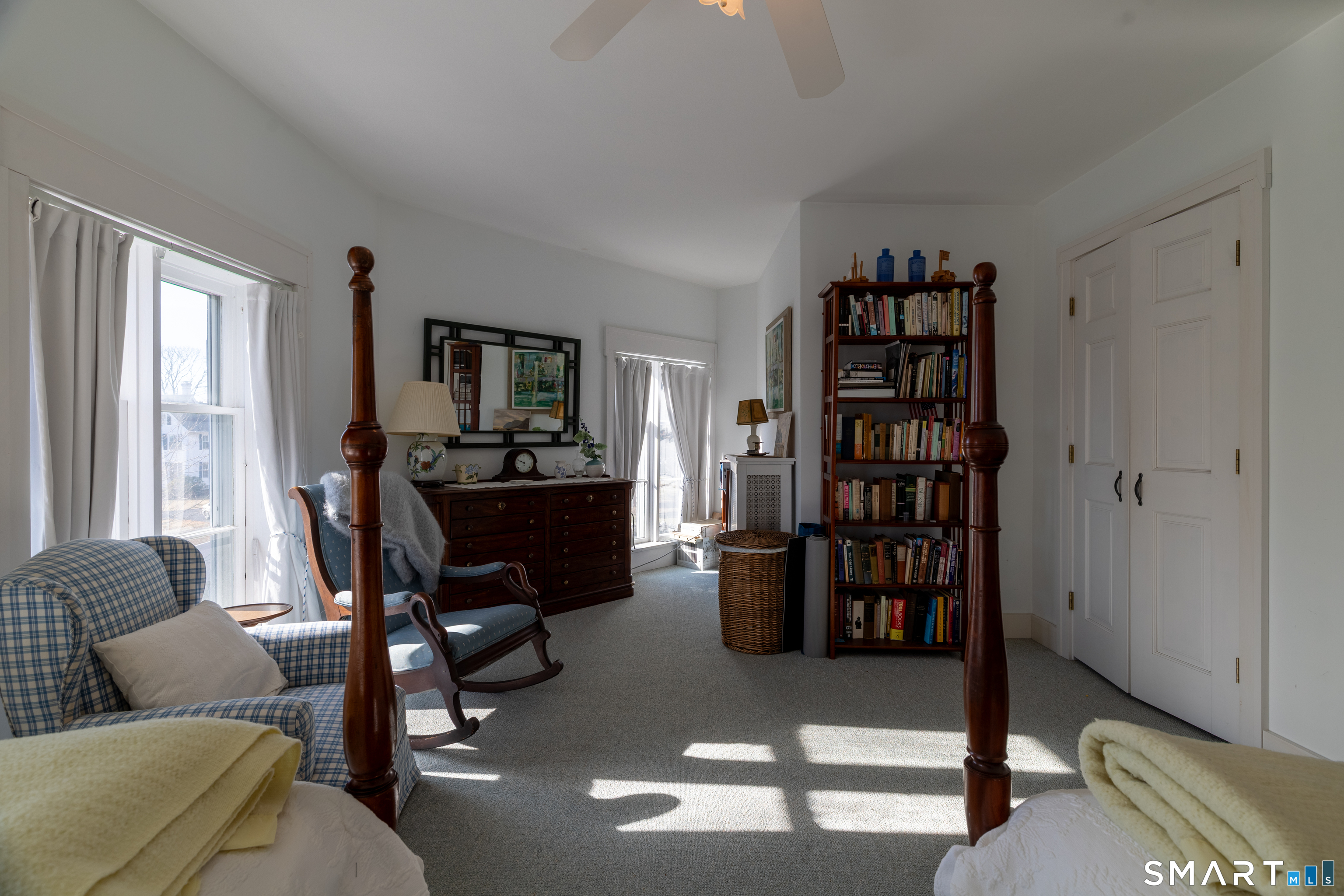 8 West Mystic Avenue Groton, CT 06355 - Photo 27 of 40 a living room with furniture a bookshelf and a window