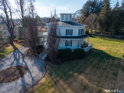 a view of a house with a yard and sitting area