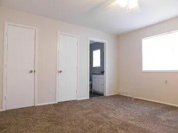 a view of an empty room with closet area