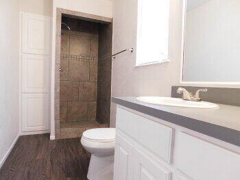 4422 57th Street Lubbock, TX 79414 - Photo 16 of 19 a bathroom with a sink a toilet and shower