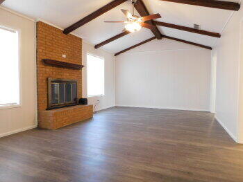 4422 57th Street Lubbock, TX 79414 - Photo 3 of 19 a view of an empty room with wooden floor and a fireplace