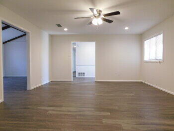 4422 57th Street Lubbock, TX 79414 - Photo 6 of 19 a view of an empty room with wooden floor and a window