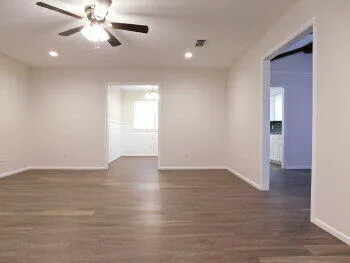 wooden floor in an empty room with a window
