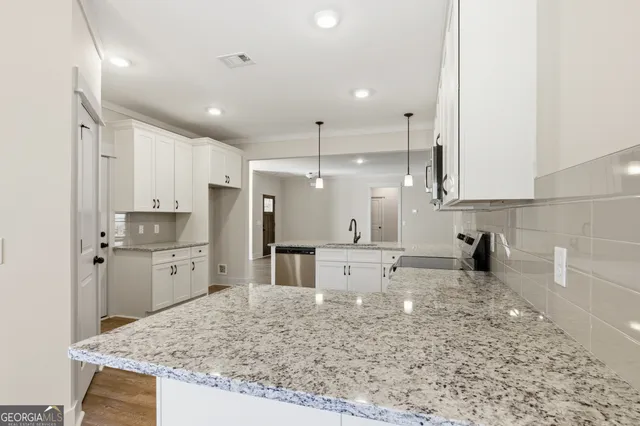 a kitchen with refrigerator and cabinets